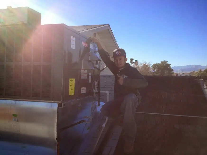 HVAC technician performing Air Duct Repair on a rooftop unit in El Paso de Robles (Paso Robles)